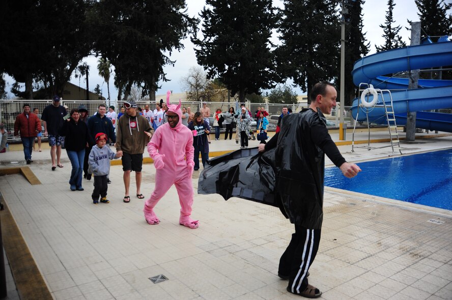 Participants parade for judges during the 2013 Polar Plunge at the base pool Jan. 12, 2013, at Incirlik Air Base, Turkey. Categories for the plunge included: wackiest costume, best theme, and the grand prize for the squadron that could stay in the longest. (U.S. Air Force photo by Senior Airman Anthony Sanchelli/Released)
