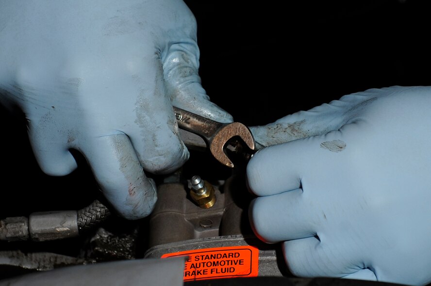 Staff Sgt. Gerald Yuhas, 8th Maintenance Squadron aerospace ground equipment journeyman, tightens a new braking system onto an mj-1 bomb-lift truck during Beverly Midnight 13-1 Kunsan Air Base, Republic of Korea, Jan. 14, 2013. Replacing the worn braking system helps prevent any mishaps while the truck is carrying a missile aboard. (U.S. Air Force photo by Senior Airman Marcus Morris/released)