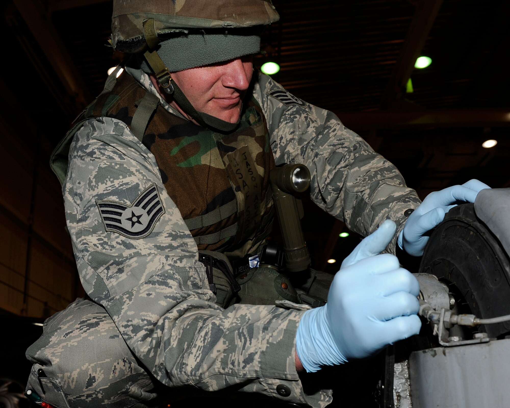 Staff Sgt. Jason Aeillo, 8th Maintenance Squadron aerospace ground equipment craftsman, takes off a worn braking system from abomb-lift truck during Beverly Midnight 13-1, Jan. 14, 2013. Replacing the worn braking system helps keep the truck from crashing while carrying a missile aboard. (U.S. Air Force photo by Senior Airman Marcus Morris/Released)