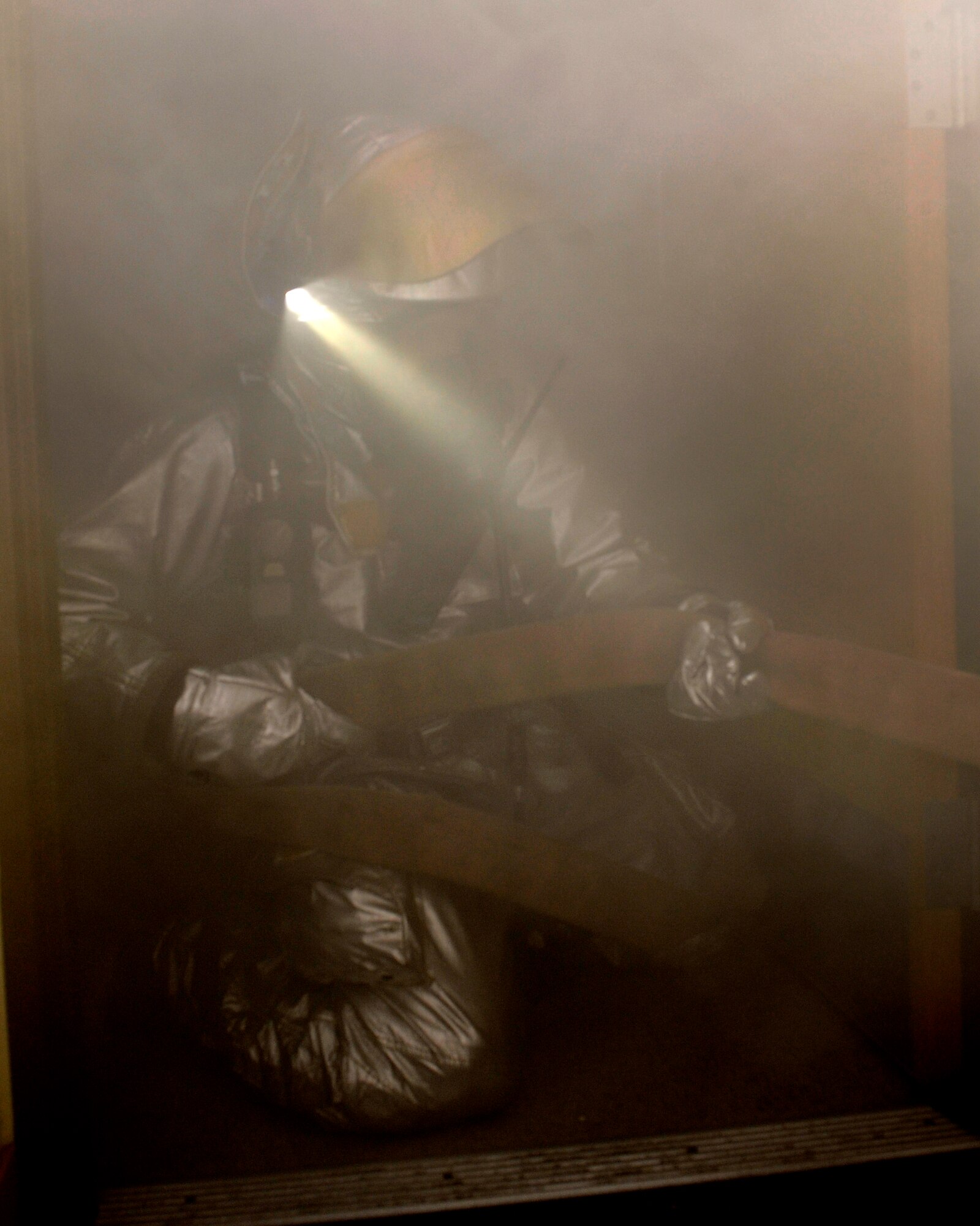 Senior Airman Aaron Strayhorn, 8th Civil Engineer Squadron firefighter, pulls the slack from the fire hose while fighting a fire during Beverly Midnight 13-1 at Kunsan Air Base, Republic of Korea, Jan. 14, 2013. After putting out the fire, the firefighters continued a sweep inside to check for any people still in the building. (U.S. Air Force photo by Senior Airman Marcus Morris/Released)