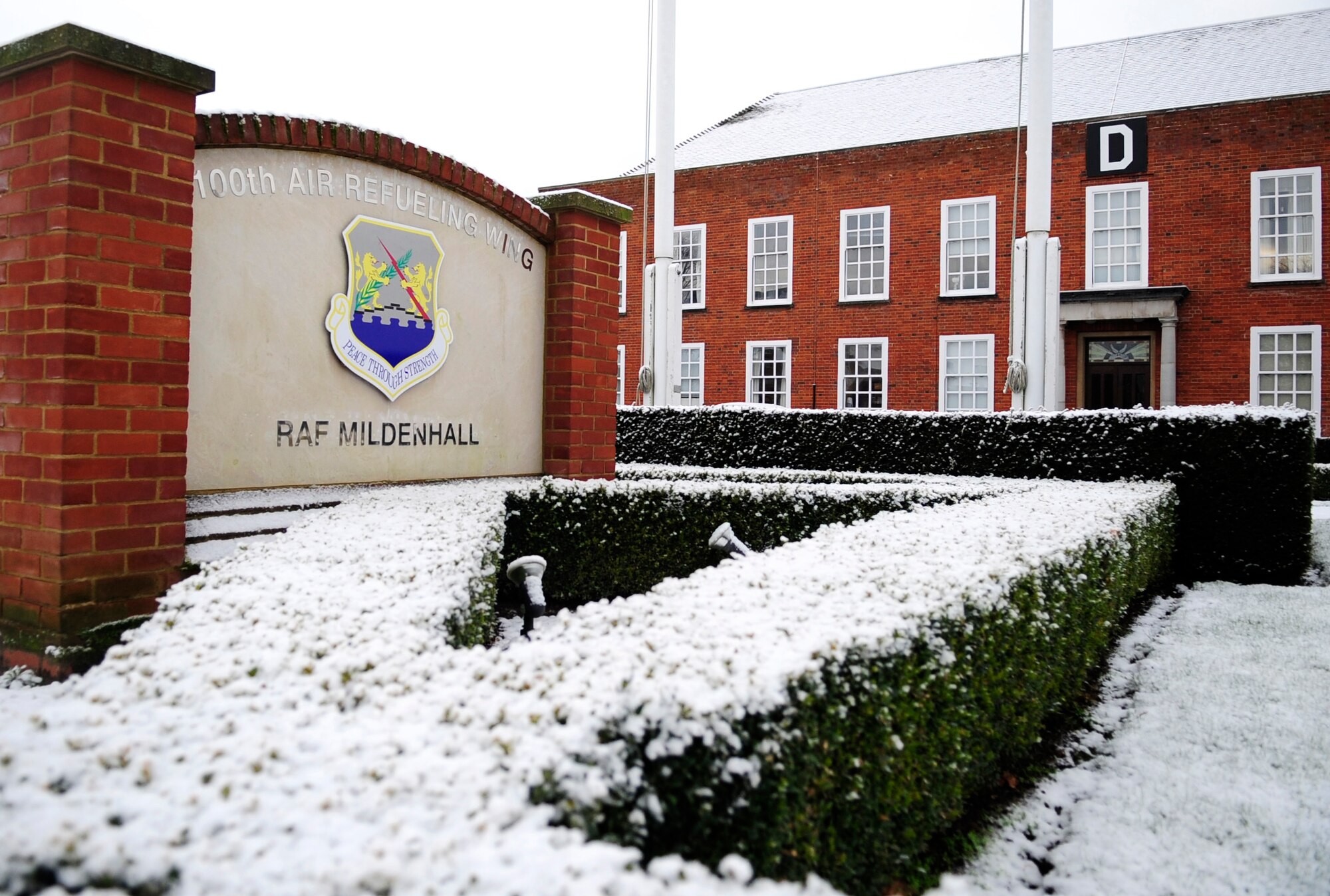 The first snow of the year rests upon the 100th Air Refueling Wing headquarters building Jan. 14, 2013, at RAF Mildenhall, England. With snow on the roads and sidewalks, extra care and attention to safety precautions is essential to avoid mishaps.  For updates on road conditions for RAF Mildenhall, visit the base’s Facebook page. (U.S. Air Force photo by Airman 1st Class Dillon Johnston/Released)