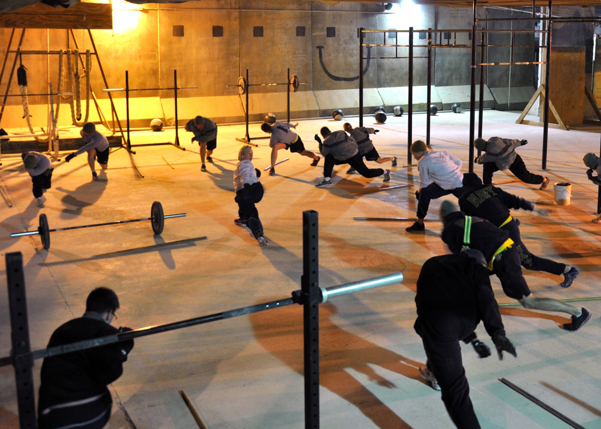 Capt. Lesley Lilly, 451st Expeditionary Force Support Flight commander and a volunteer CrossFit coach at Kandahar Airfield, leads her class in stretching before their workout on Jan. 14. Lilly, deployed here from Joint Base San Antonio-Lackland, coaches a 5 a.m. CrossFit class six days a week. (U.S. Air Force photo/Master Sgt. Russell Martin)