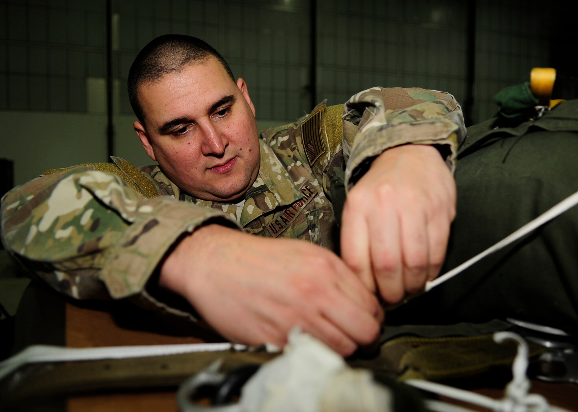 Tech. Sgt. Francisco Moreno, 321st Special Tactics Squadron aircrew flight equipment NCO in charge, finishes rigging a pallet containing operational equipment Jan. 10, 2013 at RAF Mildenhall, England. (U.S. Air Force photo by Airman 1st Class Dillon Johnston/Released)
