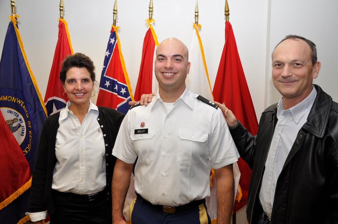 Newly promoted Capt. Corey T. Wolff is flanked by his parents, Dona and Ted Wolff of Chatham, Ohio after they placed his new rank insignia on his uniform during a Dec. 7, 2012 promotion ceremony at the U.S. Army Corps of Engineers Nashville District. (USACE photo by Fred Tucker)