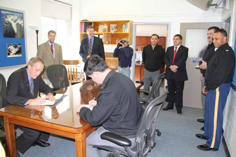 On left ERDC Cold Regions Research and Engineering Laboratory Director Dr. Robert Davis sits opposite Brig. Gen. Menanteau, Chilean Army, recently to sign an Information Exchange Agreement for extreme environments.