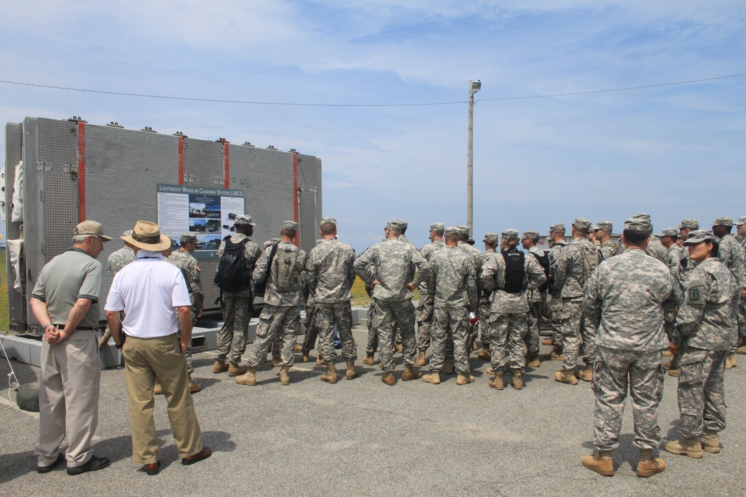 Participants in the 2012 Joint Logistics Over the Shore exercise, held at Fort Story, Va., are briefed by researchers on the ERDC-developed Lightweight Modular Causeway System. 