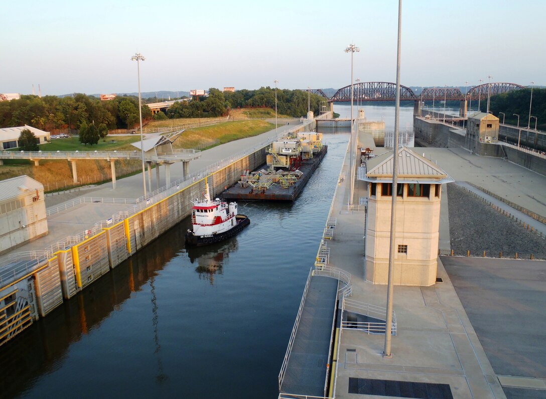 A tugboat, the M/V Mr. Russell, pulls a barge through the chamber at McAlpine Locks and Dam on the Ohio River at Louisville, Ky.

(US Army Corps of Engineers photo by Charles Gauld)   