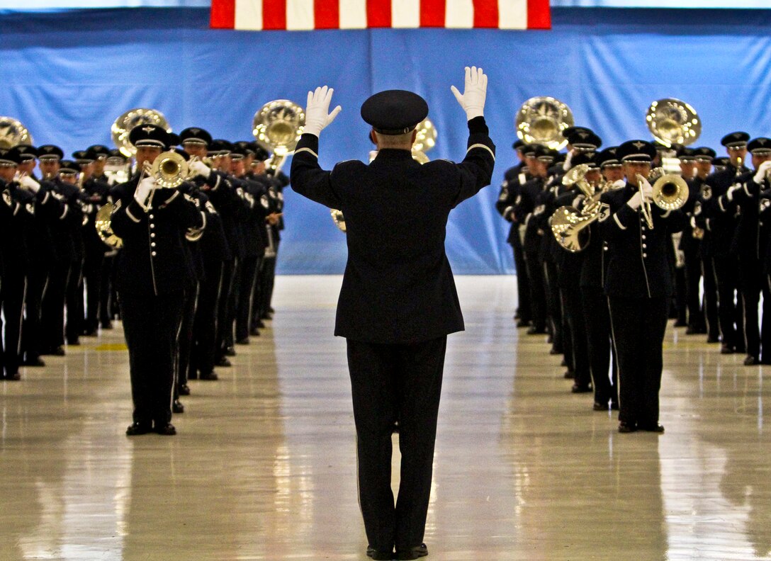 Air Force Col. Larry H. Lang, commander of the Air Force Band, conducts as the band plays the "U.S. Air Force Song" during an inaugural parade dress rehearsal on Joint Base Andrews, Md., Jan. 11, 2013.