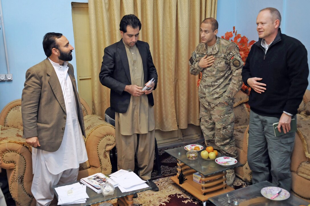 Ray Sudweeks, right, U.S. State Department representative, and U.S. Navy Cmdr. Louis McCray, second from right, make comments at the end of a meeting with Sa'ed Ahmad, Farah City mayor, left, at his office in Farah City, Afghanistan, Jan. 13. 2013. McCray is the commander of Provincial Reconstruction Team Farah.