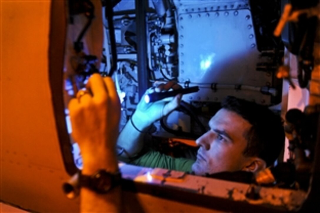 U.S. Navy Petty Officer 1st Class Justin Sexton inspects the gun cavity of an F/A-18E Super Hornet aboard the aircraft carrier USS John C. Stennis in the U.S. 5th Fleet area of responsibility, Jan. 9, 2013. The Stennis is conducting maritime security operations, theater security cooperation efforts and support missions for Operation Enduring Freedom. Sexton is an aviation technician and the aircraft is assigned to Strike Fighter Squadron 14.