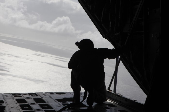 A Marine with the Special Operations Training Group, 31st Marine Expeditionary Unit, monitors the jump space for parachuting Marines on a C-130 Hercules aircraft during preliminary training here, Jan. 9. The training was part of the semiannual Realistic Urban Training Exercise, a long-range raid scenario to raise the proficiency of the MRF. The 31st MEU is the only continuously forward-deployed MEU and the Marine Corps’ force in readiness in the Asia-Pacific region.