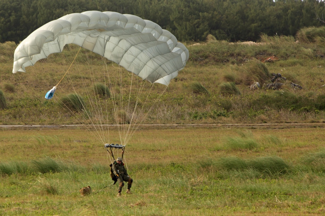 A Marine with the Force Reconnaissance Platoon, Maritime Raid Force, 31st Marine Expeditionary Unit, parachutes into the a training area at Anderson Air Force Base here, Jan 9. The training was part of the semiannual Realistic Urban Training Exercise, a long-range raid scenario to raise the proficiency of the MRF. The 31st MEU is the only continuously forward-deployed MEU and the Marine Corps’ force in readiness in the Asia-Pacific region.