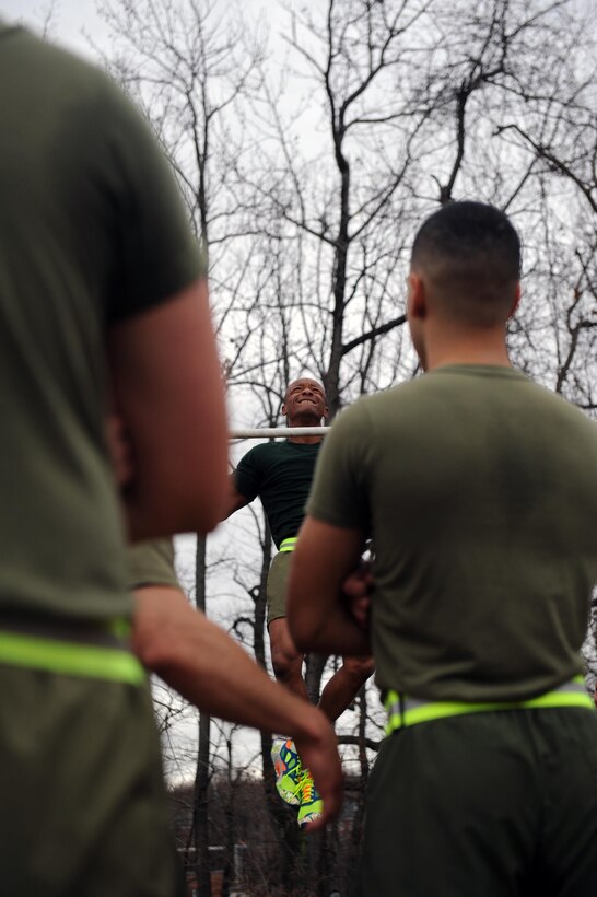 Gunnery Sgt. Alex Brown, faculty advisor, Sergeants Course, Staff Non-Commissioned Officer Academy demonstrates the proper pull up during physical fitness training for Sergeants Course on Jan. 14. Brown also ran with the platoon of sergeants on their 3.5-mile course tour of the base. 