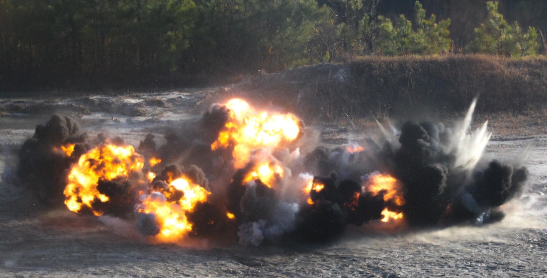 A fireball erupts from a ring of fire, January 10, at Engineer Training Area 3, a circuit of explosives that Marines put together moments before as part of the basics learned by Marines during the three-day classes and one day of rehearsals. What the instructors wanted the Marines to really gain from this training were the basics. Learning the basics here offers the Marines a foundation to build on for the future, said Sgt. Steven Kenner, a chief instructor with 2nd CEB.