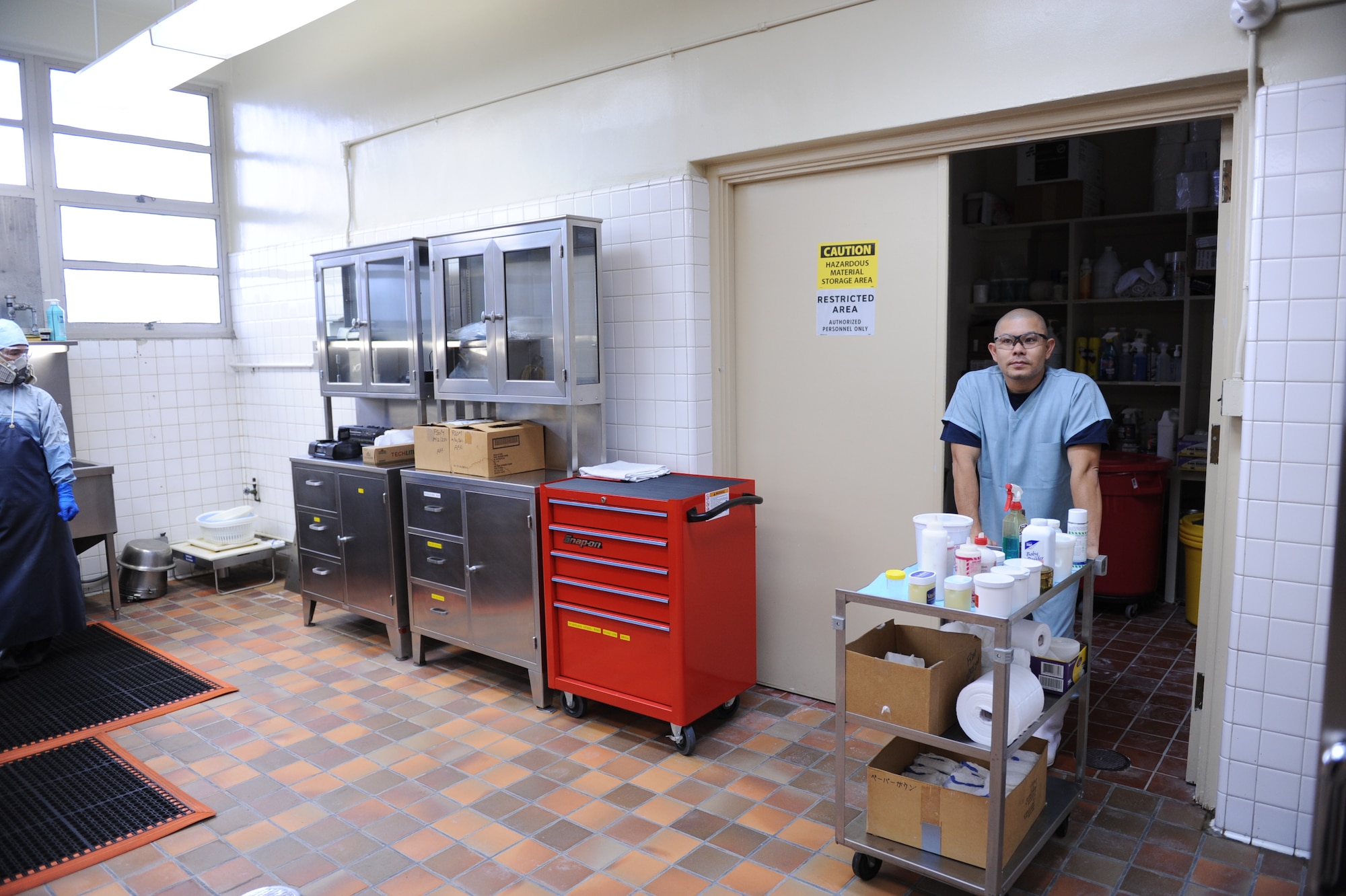 Ryo Nakasone, a mortuary attendant, pushes out a cart of products that might be needed during the embalming process at the U.S. Air Force Mortuary on Camp Kinser, Japan, Jan. 9, 2013. Embalming is performed for both sanitary and cosmetic reasons. (U.S. Air Force photo/ Airman 1st Class Brooke P. Doyle)