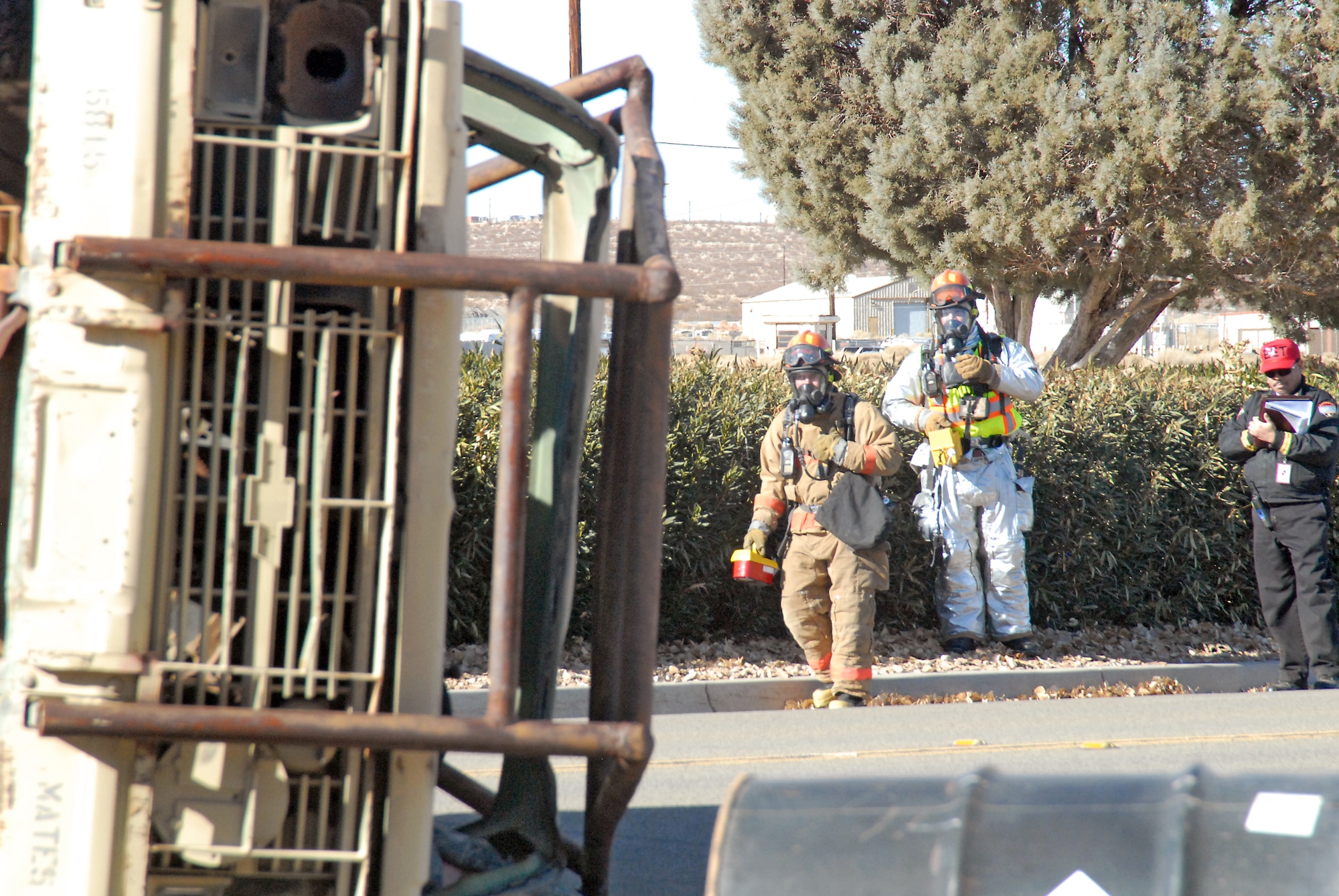 Members of the Edwards AFB Fire Department take HAZMAT readings before attempting to treat simulated casualties during the exercise. (U.S. Air Force photo by Kenji Thuloweit)