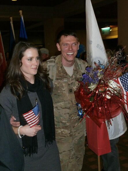 KIRTLAND AFB, N.M. -- Capt. Mike Gifford is welcomed home Jan. 13 at the Albuquerque Sunport by his girlfriend, Laura Keck, along with friends, coworkers and members of the Rio Rancho chapter of the Blue Star Mothers. Gifford, assigned to the Air Force Safety Center at Kirtland Air Force Base, was deployed to Afghanistan for four months. (Photo by Lt. Col. Cindy Feldwisch)