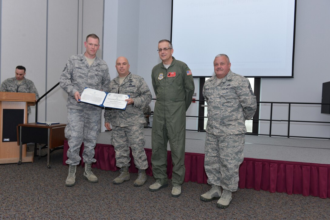 National Guard Master Sgt. Raymond Evensen receives recognition for outstanding performance from Col. Kenneth Dale, Air National Guard Logistics Compliance Assessment Program (LCAP) Team Chief during the 165th Airlift Wing's LCAP inspection, January 15, 2013 at Savannah Air National Guard Base in Garden City, Ga. 165AW Air Commander, Col. Rainer Gomez and Command Chief Master Sgt. Hewshal Thornton acknowlege Evensen's accomplishments that contributed to Quality Assurance in receiving an Outstanding rating. (National Guard photo by Tech. Sgt. Charles Delano/released)