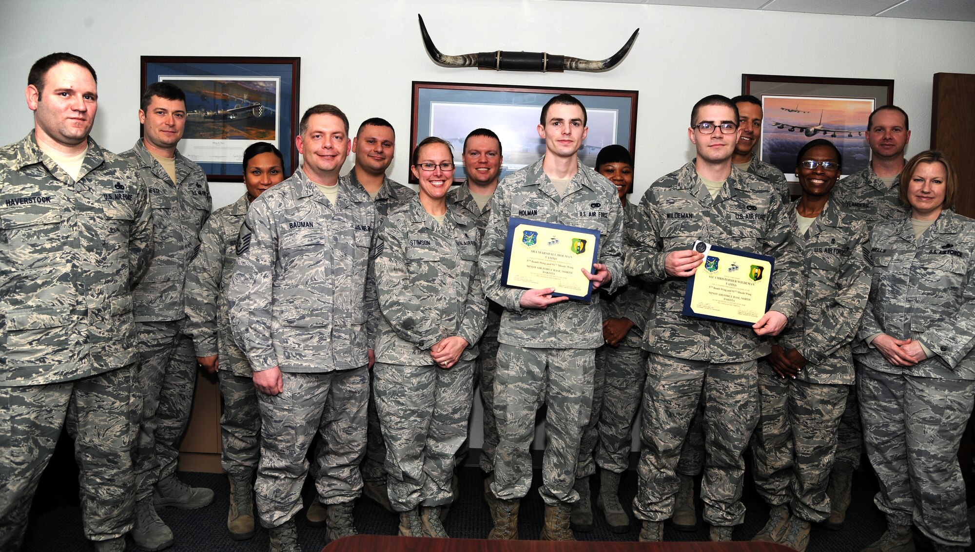 MINOT AIR FORCE BASE, N.D. -- Senior Airman Marshall Holman and Airman 1st Class Christopher Wildeman, both assigned to the 5th Aircraft Maintenance Squadron, were recognized by the Minot Top 3 here, Jan. 8. Holman and Wildeman were acknowledged for their extraordinary efforts and response in saving a child who was accidently locked in a car during a particularly hot day in September 2012. (U.S. Air Force photo/Airman 1st Class Andrew Crawford)