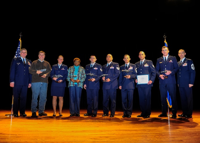 Colonel Al Miller, 437th Airlift Wing vice commander (left), and Chief Master Sgt. Larry Williams, 437th AW command chief (right), congratulate the 437th Airlift Wing Fourth Quarter Award Winners after a ceremony Jan. 11, 2013, at Joint Base Charleston – Air Base, S.C. (Left to right) Arthur Cormier, 437th Aerial Port Squadron, Senior Airman Leslie Carey, 437th Maintenance Squadron, Betty Brisbon, 437th Aerial Port Squadron, Staff Sgt. James Sweet, 437th Operations Support Squadron, Tech. Sgt. Marcus Parker, 437th Maintenance Operations Squadron, Senior Master Sgt. Donald Sturm, 437th Aircraft Maintenance Squadron, Tech. Sgt. David Warner, 437th Maintenance Group, 2nd Lt. Daniel Musleve, 437th APS. Not pictured is Capt. Coningsby Burdon,16th Airlift Squadron. The winners were nominated for creating a process which would include better coverage of maintenance support activities, increase quality of life, even the workload for all shifts and create more reliable work schedules for maintenance workers. (U.S. Air Force photo/Staff Sgt. Rasheen Douglas) 
