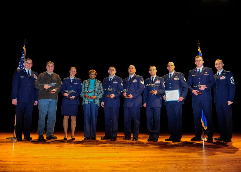 Colonel Al Miller, 437th Airlift Wing vice commander (left), and Chief Master Sgt. Larry Williams, 437th AW command chief (right), congratulate the 437th Airlift Wing Fourth Quarter Award Winners after a ceremony Jan. 11, 2013, at Joint Base Charleston – Air Base, S.C. (Left to right) Arthur Cormier, 437th Aerial Port Squadron, Senior Airman Leslie Carey, 437th Maintenance Squadron, Betty Brisbon, 437th Aerial Port Squadron, Staff Sgt. James Sweet, 437th Operations Support Squadron, Tech. Sgt. Marcus Parker, 437th Maintenance Operations Squadron, Senior Master Sgt. Donald Sturm, 437th Aircraft Maintenance Squadron, Tech. Sgt. David Warner, 437th Maintenance Group, 2nd Lt. Daniel Musleve, 437th APS. Not pictured is Capt. Coningsby Burdon,16th Airlift Squadron. The winners were nominated for creating a process which would include better coverage of maintenance support activities, increase quality of life, even the workload for all shifts and create more reliable work schedules for maintenance workers. (U.S. Air Force photo/Staff Sgt. Rasheen Douglas) 
