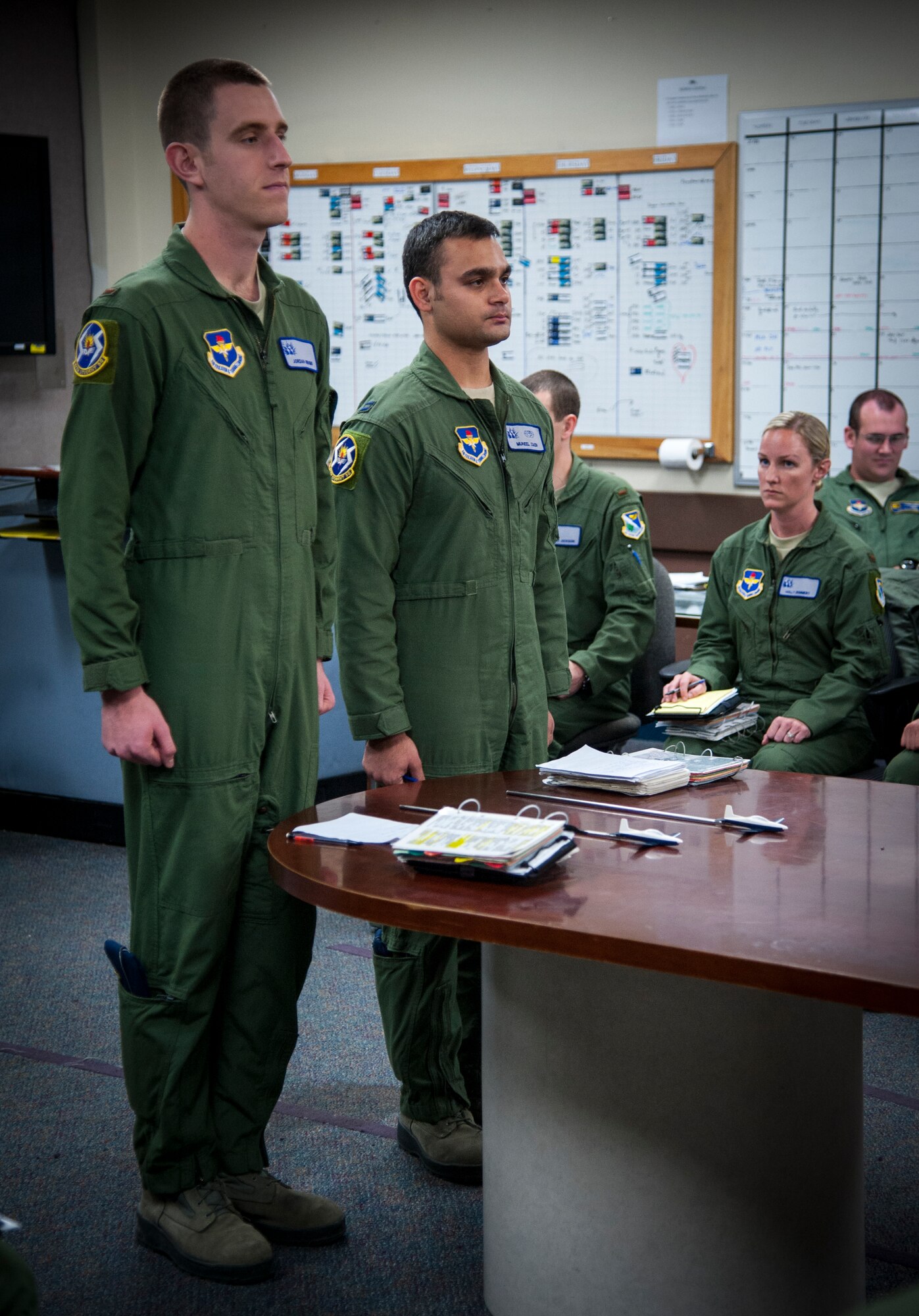 Capt. Muneel Zaidi and 2nd Lt. Jordan Wright, 47th Student Squadron student pilots assigned to Aces Flight stand in front of their class to answer questions during ‘standup’ in the Aces’ flight room at Anderson Hall on Laughlin Air Force Base, Texas, Jan. 10, 2013. ‘Standup’ is a stressful procedures evaluation which allows instructors to evaluate how students will perform in situations they may face in the air. (U.S. Air Forces photo/Senior Airman Nathan Maysonet)