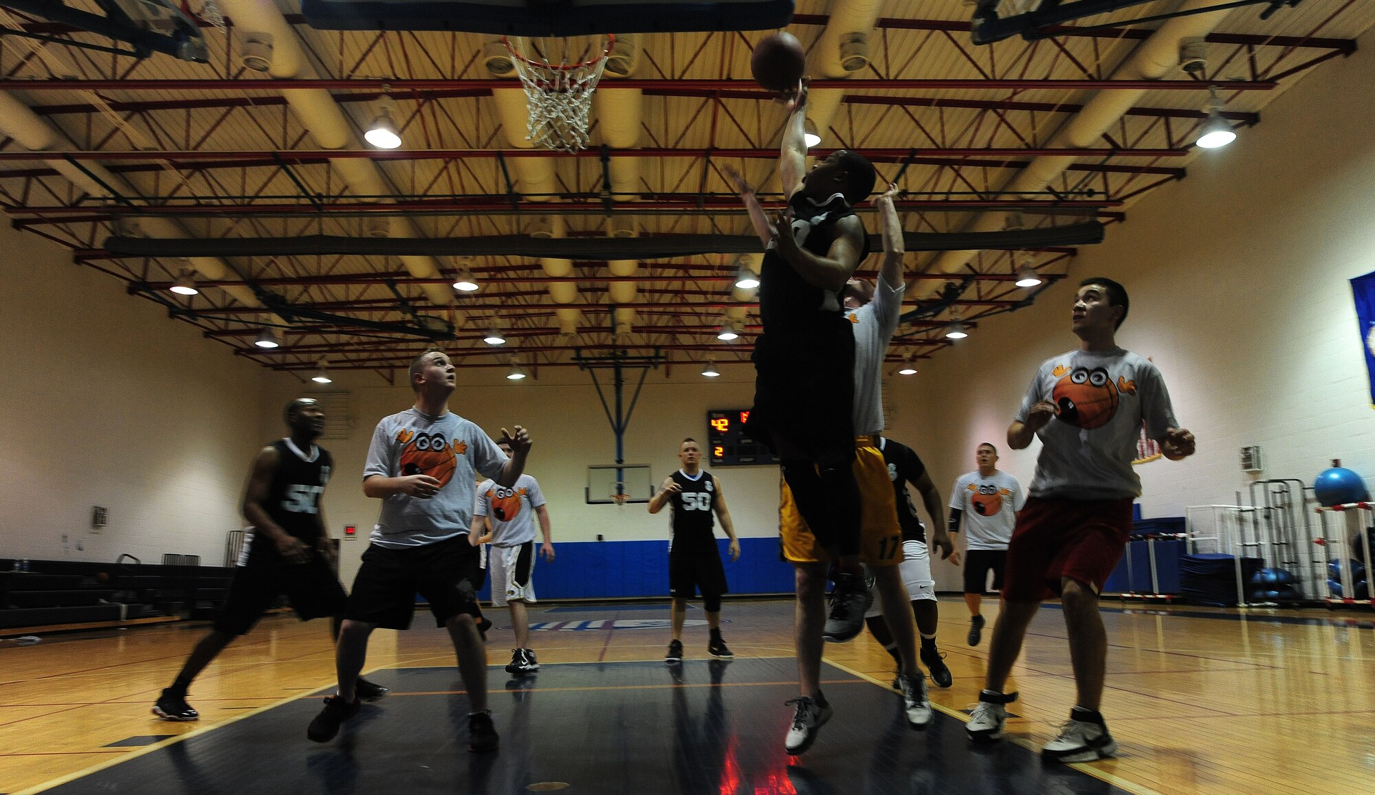 WHITEMAN AIR FORCE BASE, Mo. -- A member from the 509th Security Forces-B intramural basketball team grabs an offensive rebound over a member of the 509th Aircraft Maintenance Squadron basketball team during the 509th SFS-B's 52-42 victory Jan. 8. The victory was the 509th SFS-B fifth of the season. (U.S. Air Force photo/Staff Sgt. Nick Wilson) (Released) 
