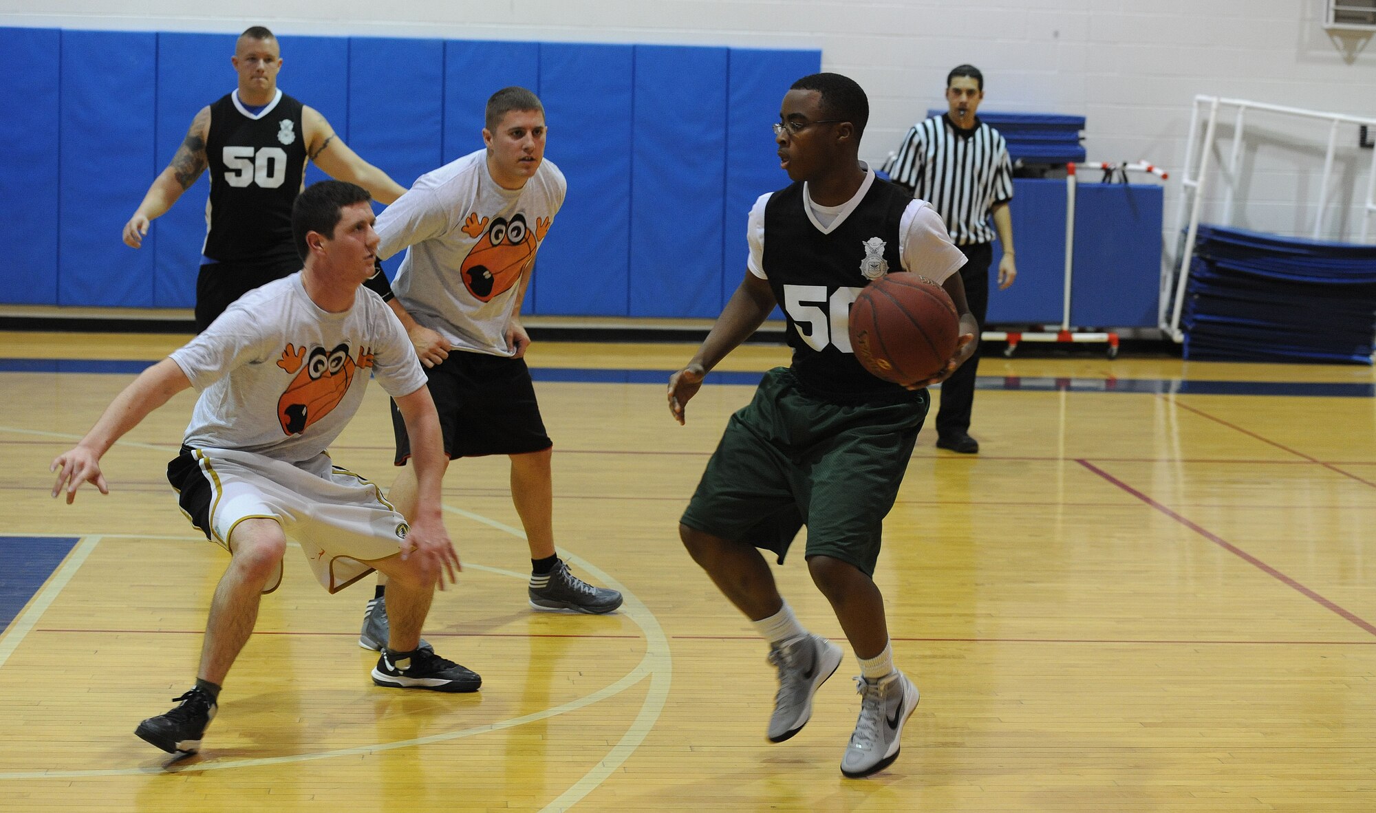 WHITEMAN AIR FORCE BASE, Mo. -- Keenan Fleming, 509th Security Forces-B intramural basketball team member, dribbles the ball during his team's 52-42 victory over the 509th Aircraft Maintenance Squadron team, Jan. 8. The victory gave the 509th SFS-B a record of five wins and three losses. (U.S. Air Force photo/Staff Sgt. Nick Wilson) (Released)