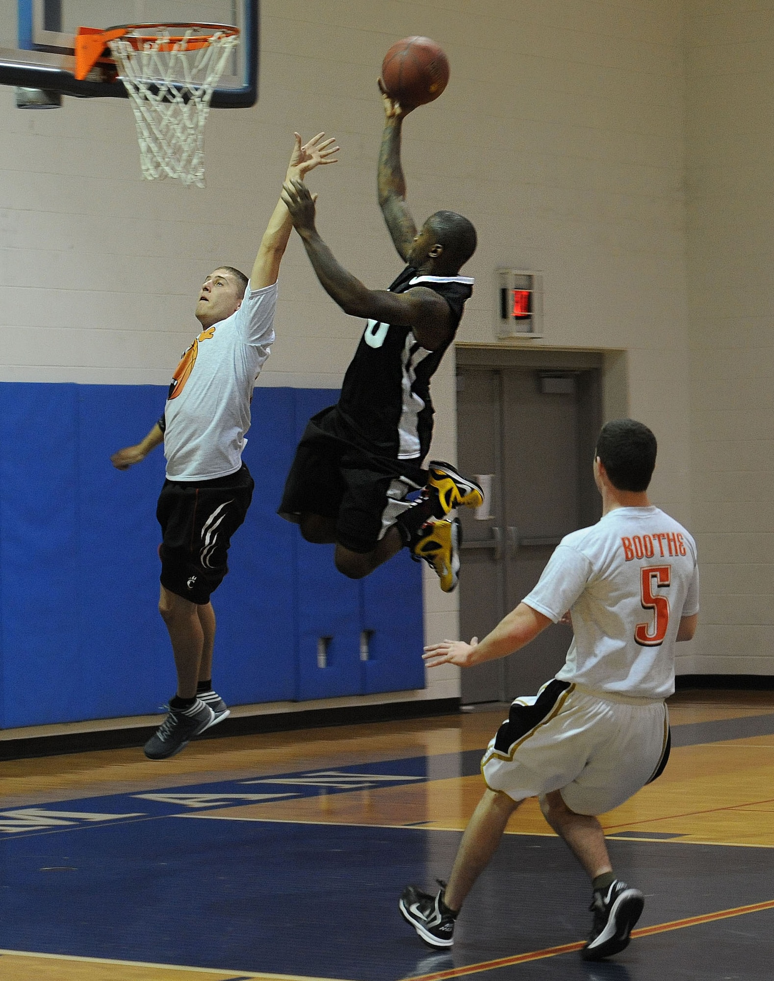 WHITEMAN AIR FORCE BASE, Mo. -- Antonio Chatman, 509th Security Forces-B intramural basketball team member, attempts a layup over a member from the 509th Aircraft Maintenance Squadron team, Jan. 8. The 509th SFS-B defeated the 509th AMXS 52-42. (U.S. Air Force photo/Staff Sgt. Nick Wilson) (Released)