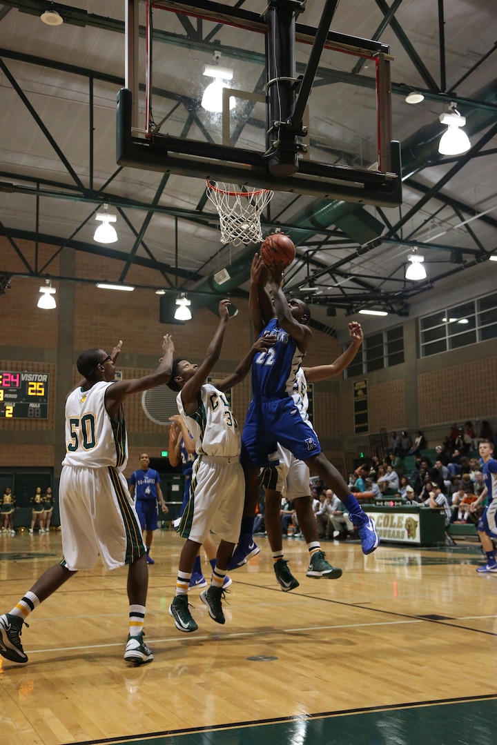 Bryan London, Randolph High School Ro-Hawks basketball player, takes a shot against the Robert G. Cole High School Cougars Jan 11. at Joint Base San Antonio-Fort Sam Houston. The Ro-Hawks have an overall record of 16-3 and a 4-1 division record. (U.S. Air Force photo by Joshua Rodriguez)