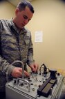 Airman 1st Class Jason Konrad, 2nd Operations Support Squadron aircrew flight equipment, uses an oxygen mask test unit to test a piece of equipment on Barksdale Air Force Base, La., Jan. 15. The machine is used to test aircrew equipment for leaks and simulates an altitude of up to 48,000 feet. (U.S. Air Force photo/Airman 1st Class Benjamin Gonsier)