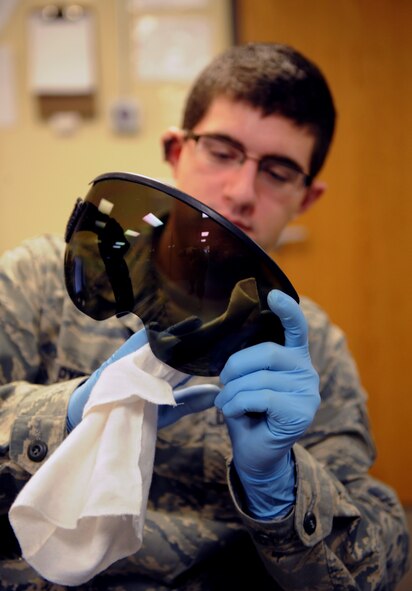 Airman 1st Class Bryan Pyszk, 2nd Operations Support Squadron aircrew flight equipment, cleans an MBU-20/P visor on Barksdale Air Force Base, La., Jan. 15. AFE Airmen inspect the visors for scratches in the aircrew member's critical vision area as well as clean them regularly. (U.S. Air Force photo/Airman 1st Class Benjamin Gonsier)
