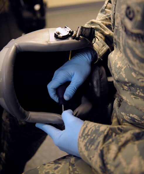 Airman 1st Class Bryan Pyszk, 2nd Operations Support Squadron aircrew flight equipment, takes a part an aircrew helmet on Barksdale Air Force Base, La., Jan. 15. The helmet is thoroughly cleaned to remove any dirt and debris that may build up and to prevent potential sickness for the wearer. (U.S. Air Force photo/Airman 1st Class Benjamin Gonsier)