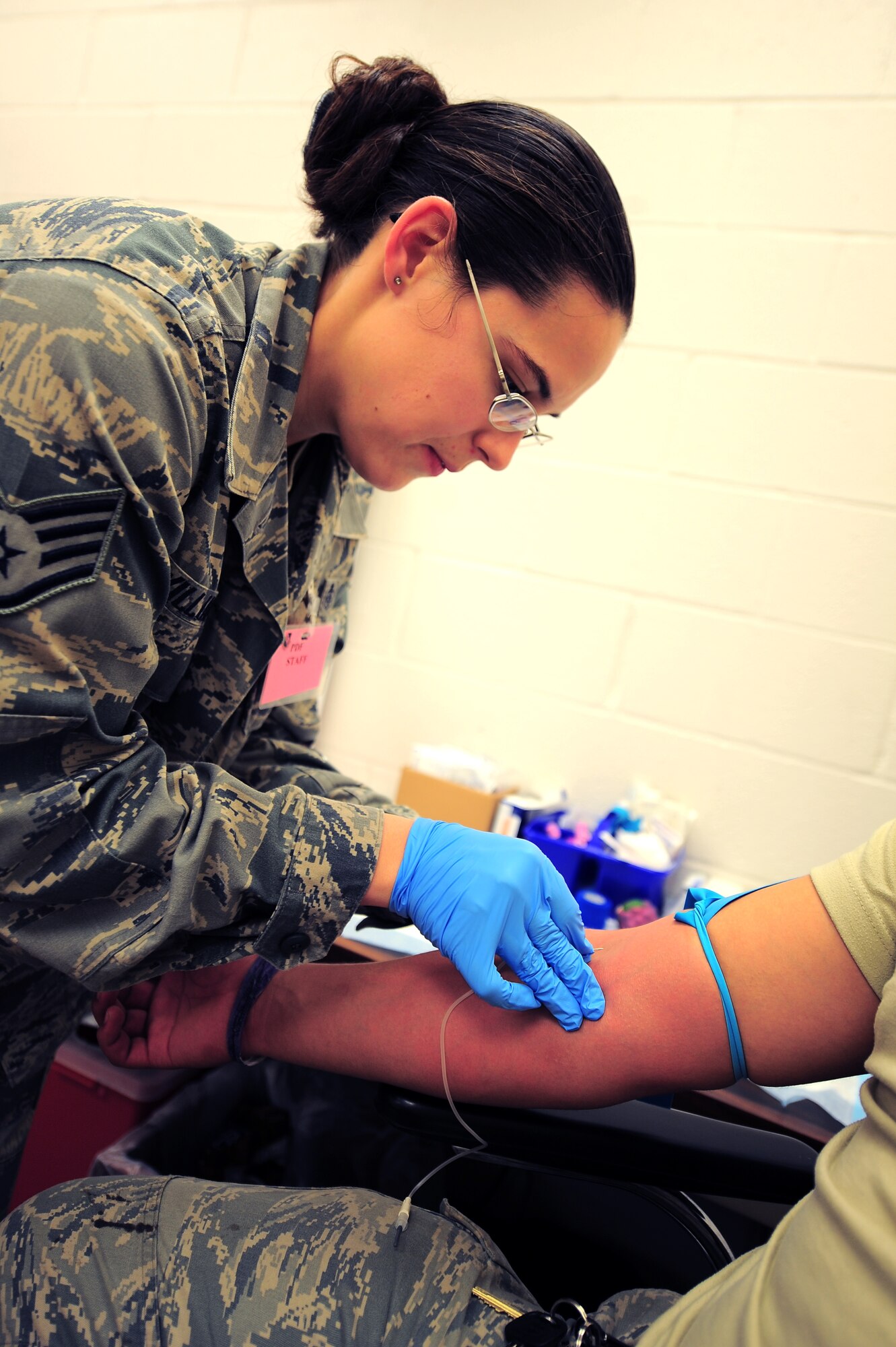U.S. Air Force Staff Sgt. Bridget Williams, 4th Medical Operations Squadron medical technician, draws blood during Operational Readiness Exercise Coronet Warrior 13-01 on Seymour Johnson Air Force Base, N.C., Jan. 14, 2013. Medical technicians at the Personnel Deployment Facility collected blood samples from Airmen to update their medical records prior to deployment. (U.S. Air Force photo/Airman 1st Class Aubrey White/Released)