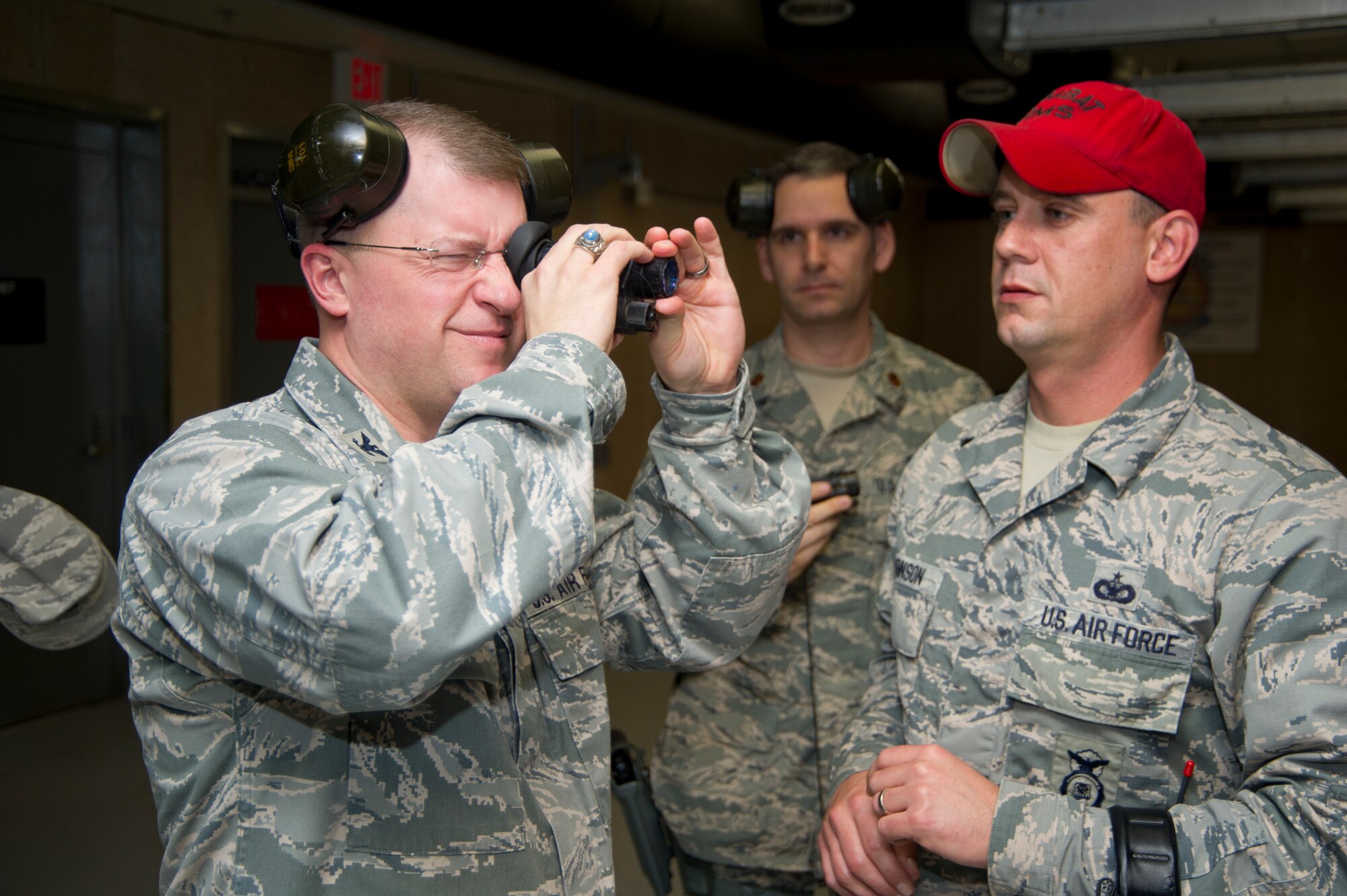 Col. John Kubinec, Installation Excellence Selection Board member, views a target at the 81st Security Forces firing range with the assistance of Tech. Sgt. Jonathan Johnson, 81st SFS combat arms, Jan. 10, 2013, at Keesler Air Force Base, Miss.  Keesler is one of the top two bases competing for the Commander-in-Chief's Annual Award for Installation Excellence with a $1 million top prize for quality of life initiatives. Keesler showed the board members various examples of team problem solving, unit cohesiveness and enhanced productivity throughout their two-day visit.  (U.S. Air Force photo by Adam Bond)