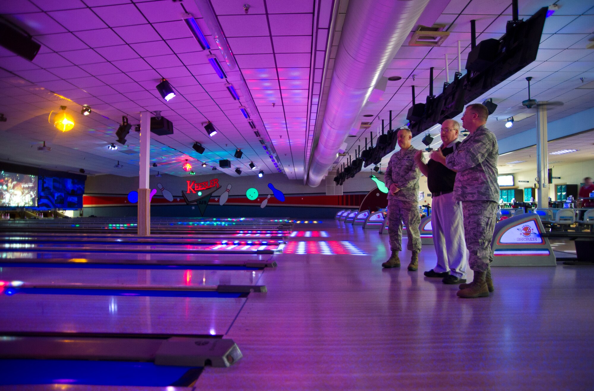 Maj. John Ponton, 81st Force Support Squadron commander, and Barton Bosarge, 81st FSS Gaude Lanes manager, demonstrate the bowling alley’s lighting techniques and sound capabilities to John Kubinec, Installation Excellence Selection Board member, Jan. 11, 2013, at Keesler Air Force Base, Miss.  Keesler is one of the top two bases competing for the Commander-in-Chief's Annual Award for Installation Excellence with a $1 million top prize for quality of life initiatives. Keesler showed the board members various examples of team problem solving, unit cohesiveness and enhanced productivity throughout their two-day visit.  (U.S. Air Force photo by Adam Bond)