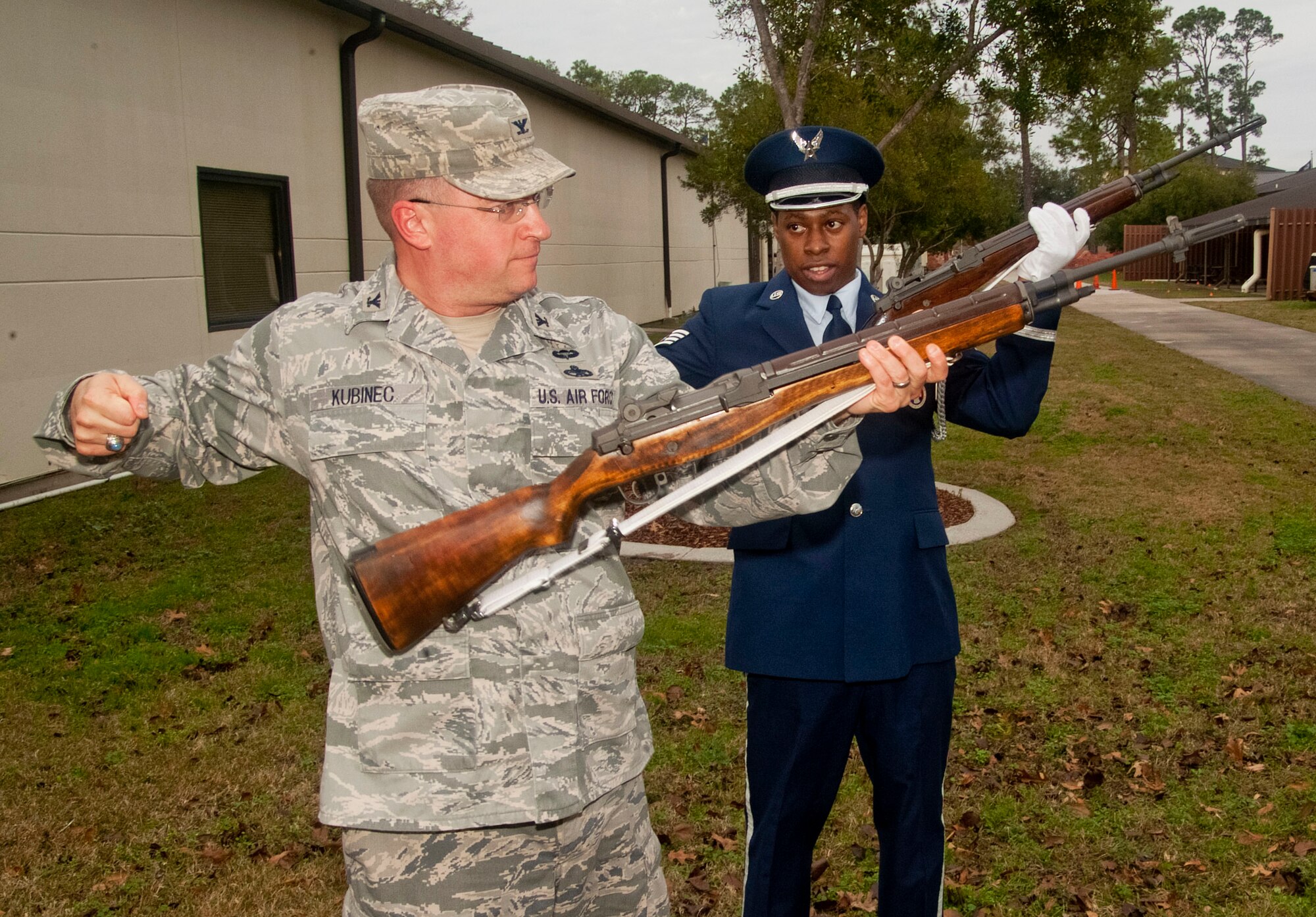 Col. John Kubinec, Installation Excellence Selection Board member, receives instruction from Staff Sgt. Lester Lane, Keesler Honor Guard member, on the proper procedure and movements required during the gun salute portion of an internment ceremony Jan. 11, 2013, outside of the Airmen Leadership School, at Keesler Air Force Base, Miss.  Keesler is one of the top two bases competing for the Commander-in-Chief's Annual Award for Installation Excellence with a $1 million top prize for quality of life initiatives. Keesler showed the board members various examples of team problem solving, unit cohesiveness and enhanced productivity throughout their two-day visit.  (U.S. Air Force photo by Herb Welch)