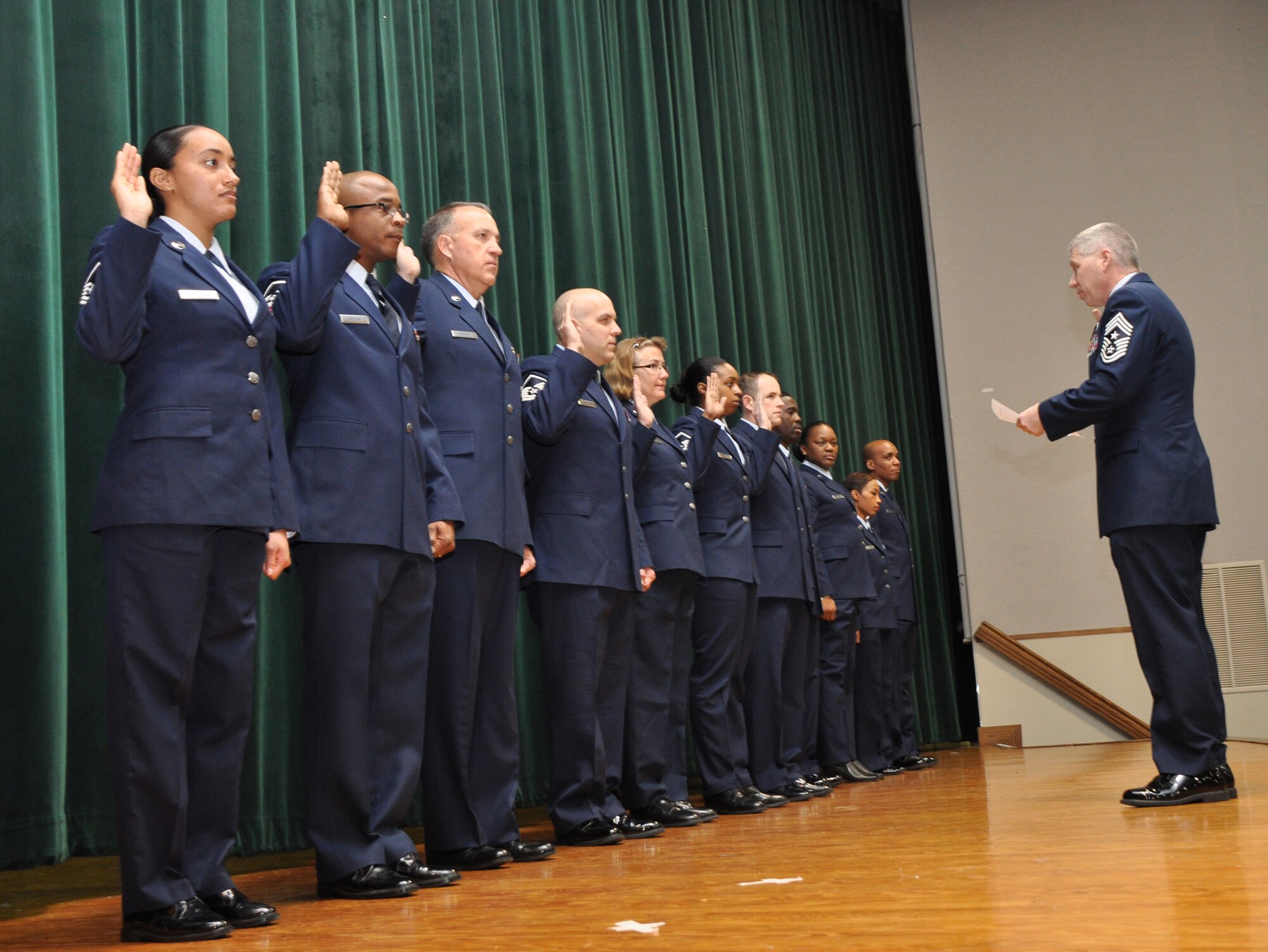 Members from the 459th Air Refueling Wing at Joint Base Andrews, Md., raise their right hands as they take an oath of induction into the Senior Non-Commissioned Officer Corps and Non-Commissioned Officer Corps, Jan. 13, 2013. The oath was taken during commander’s call where seven SNCO’s and four NCO’s were inducted into the corps. (U.S. Air Force photo/ Staff Sgt. Katie Spencer)