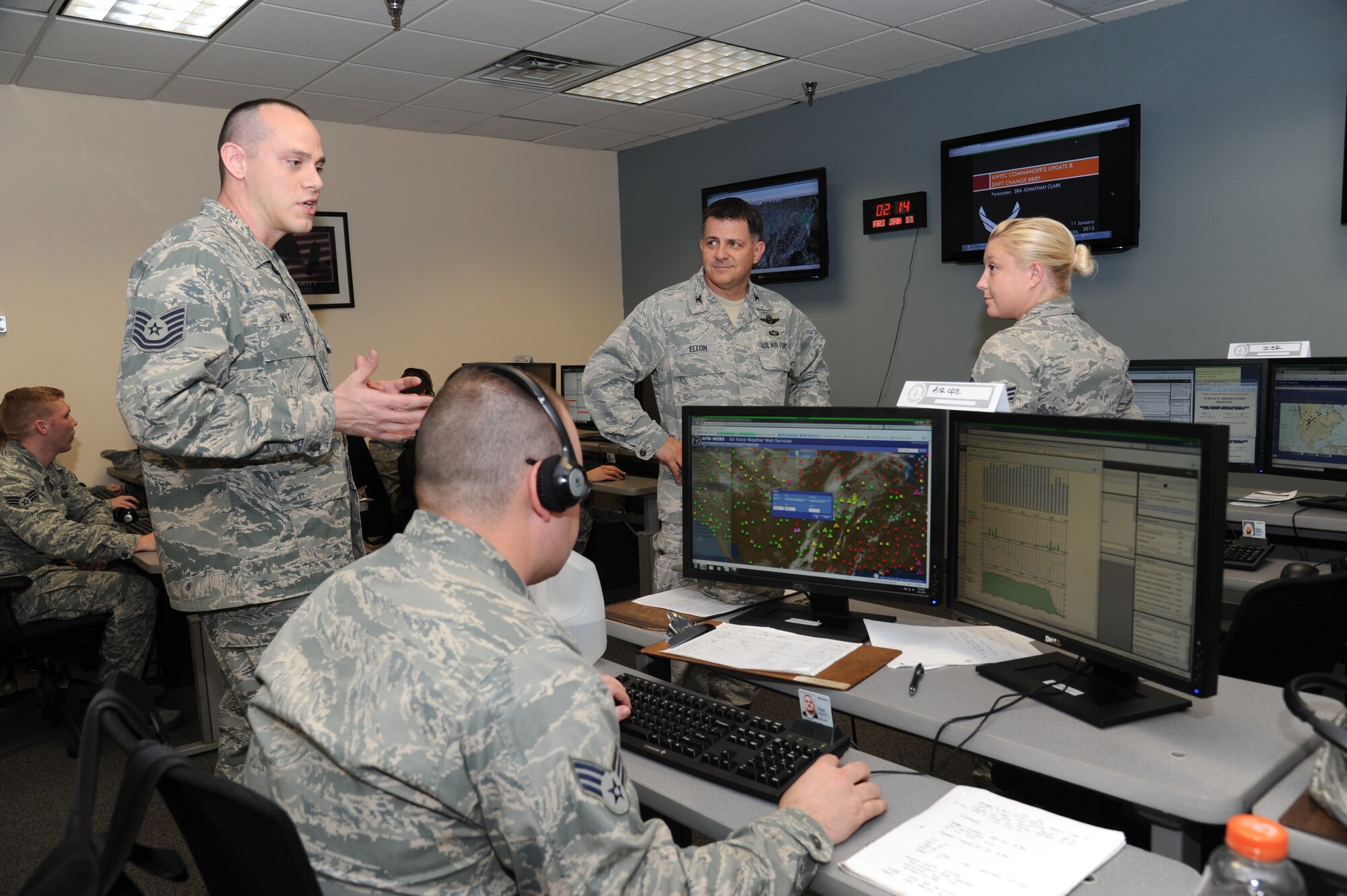 Airman 1st Class Tyler Giles-Johnson and Master Sgt. Tony Barattini, 338th Training Squadron, listen as Col. Albert Elton, Installation Excellence Selection Board member, center, uses a microwave radio for voice and data communication across the installation Jan. 11, 2013, at the Air Expeditionary Force  training area, Keesler Air Force Base, Miss.  Keesler is one of the top two bases competing for the Commander-in-Chief's Annual Award for Installation Excellence with a $1 million top prize for quality of life initiatives.  Keesler showed the board members various examples of team problem solving, unit cohesiveness and enhanced productivity throughout their two-day visit.  (U.S. Air Force photo by Kemberly Groue)