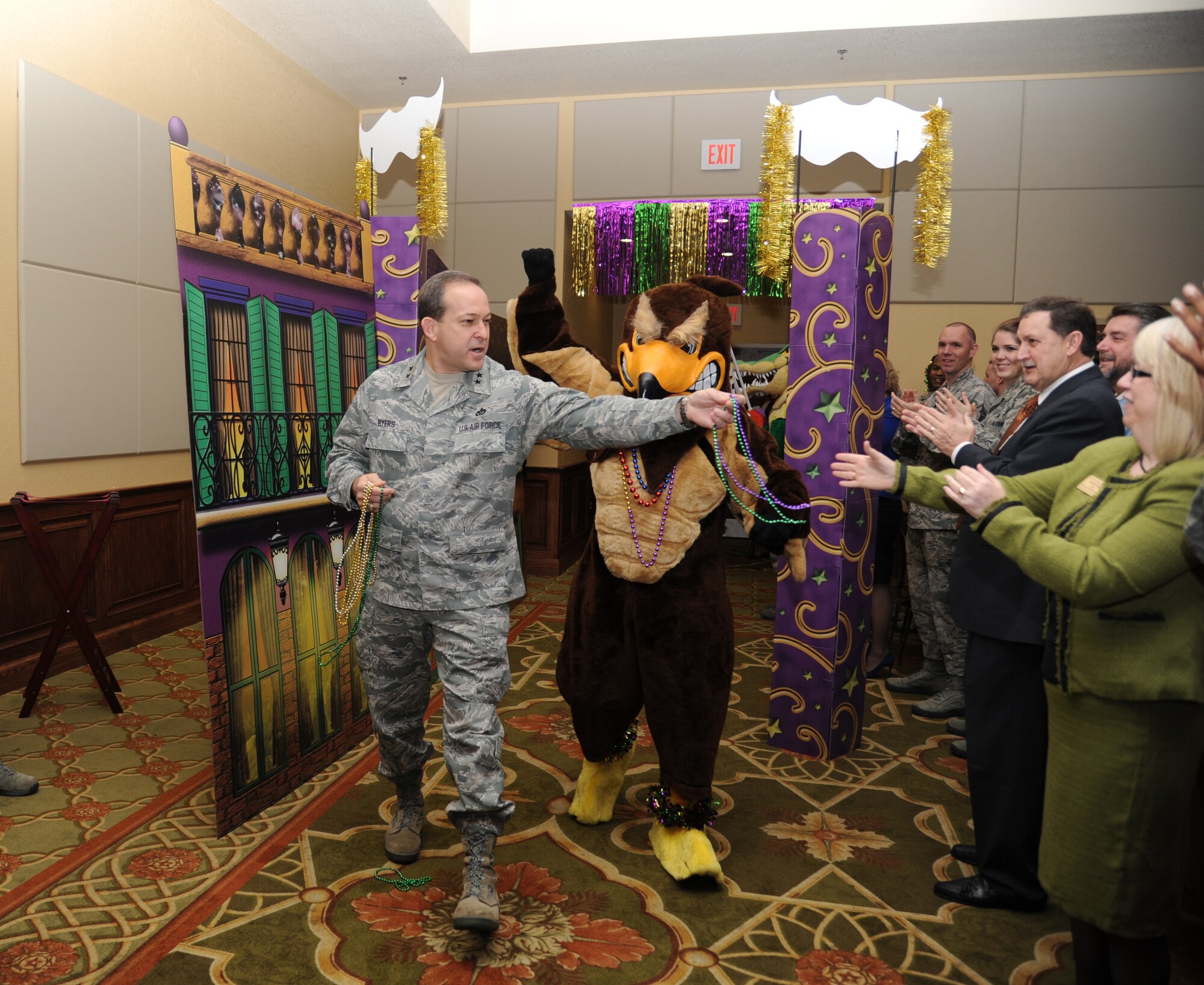 Maj. Gen. Timothy Byers, the Air Force Civil Engineer and Installation Excellence Selection Board member, is escorted by the 81st Training Support Squadron’s Falcon mascot, as they enter the Mardi Gras-themed breakfast with civic leaders and base leadership Jan. 10, 2013, at the Bay Breeze Event Center, Keesler Air Force Base, Miss.  Keesler is one of the top two bases competing for the Commander-in-Chief's Annual Award for Installation Excellence, with a $1 million top prize for quality of life initiatives.  (U.S. Air Force photo by Kemberly Groue)