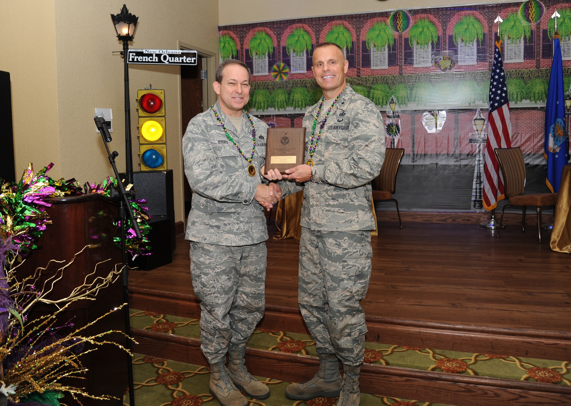 Maj. Gen. Timothy Byers, the Air Force Civil Engineer and Installation Excellence Selection Board member, presents Brig. Gen. Brad Spacy, 81st Training Wing commander, the Commander-In-Chief’s Annual Award for Installation Excellence finalist plaque during the Mardi Gras-themed kickoff breakfast Jan. 10, 2013, at the Bay Breeze Event Center, Keesler Air Force Base, Miss.  The award recognizes the people who have done the best with their base resources to support the mission.  Keesler is one of the top two bases competing for the award with a $1 million top prize for quality of life initiatives.  (U.S. Air Force photo by Kemberly Groue)