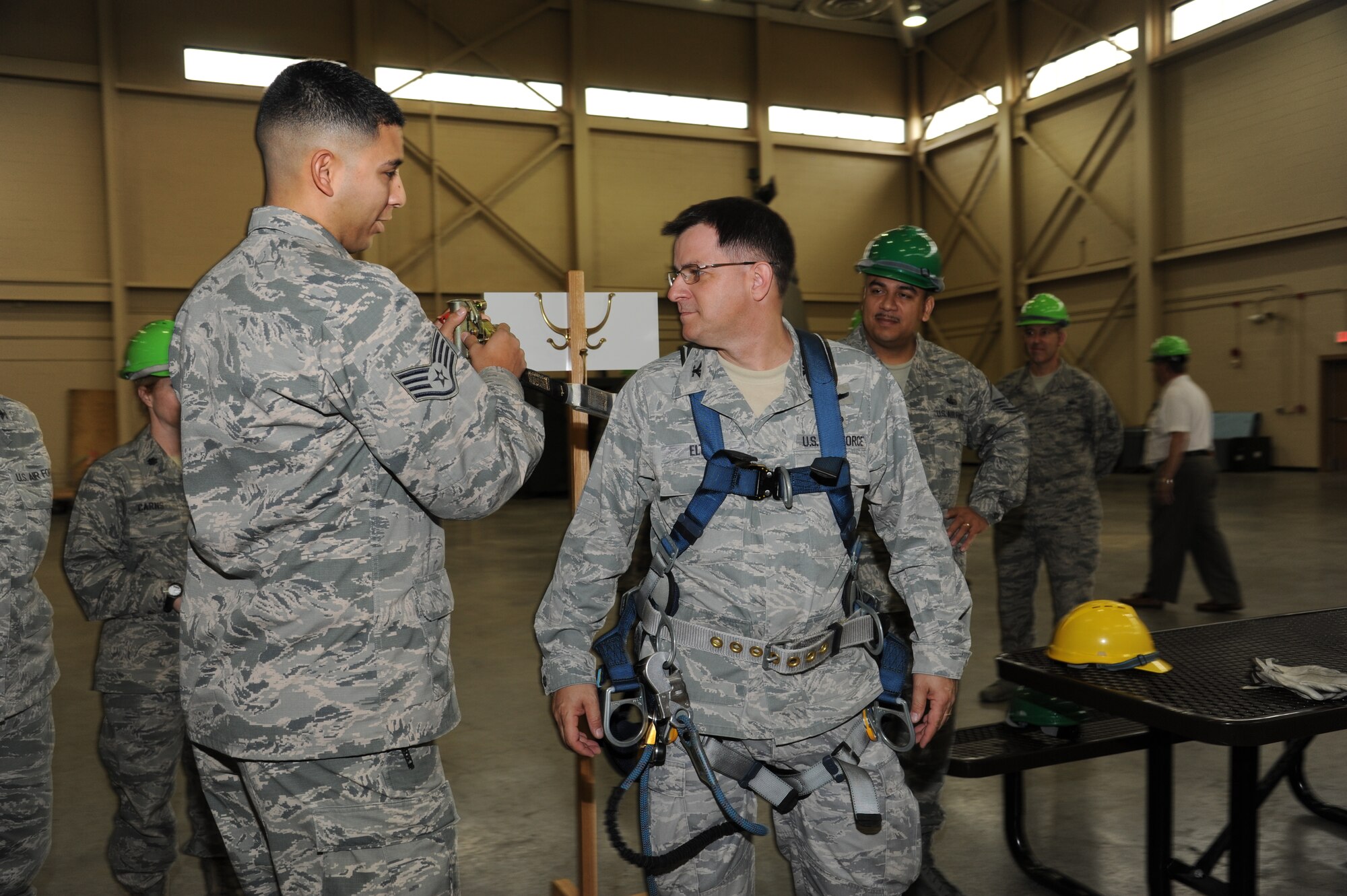 Staff Sgt. Alexis Moreno, 338th Training Squadron, assists Col. Albert Elton, Installation Excellence Selection Board member, with fastening a harness for climbing a climbing tower used for training at Matero Hall, Jan. 11, 2013, Keesler Air Force Base, Miss.   Keesler is one of the top two bases competing for the Commander-in-Chief's Annual Award for Installation Excellence, with a $1 million top prize for quality of life initiatives.  Keesler showed the board members various examples of team problem solving, unit cohesiveness and enhanced productivity throughout their two-day visit.  (U.S. Air Force photo by Kemberly Groue)