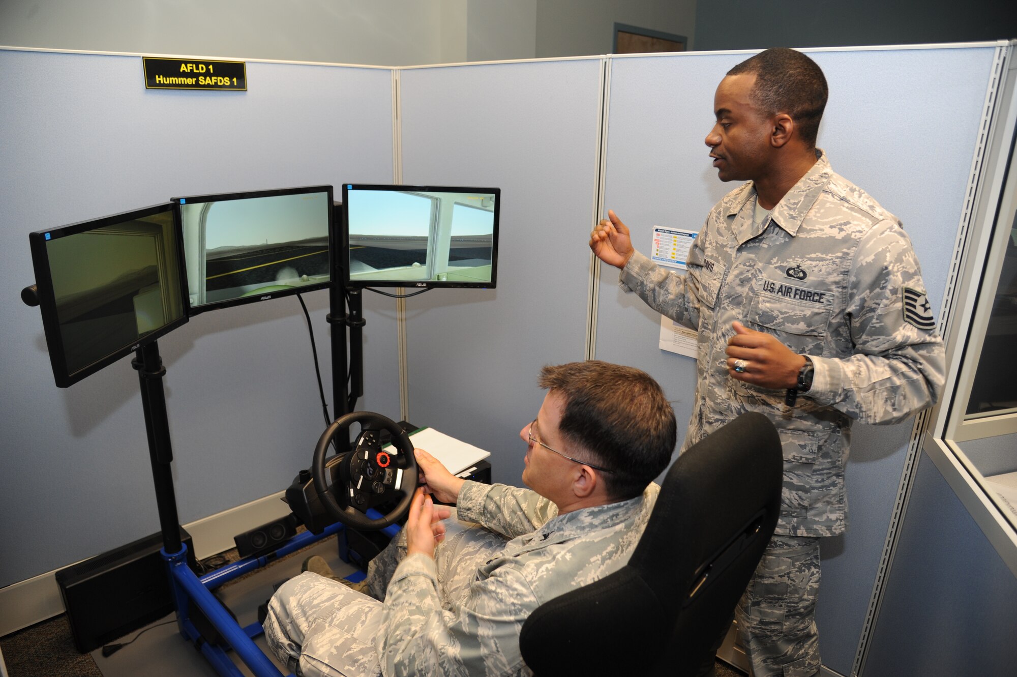 Col. Albert Elton, Installation Excellence Selection Board member, tests out an airfield driving simulator while Tech. Sgt. Norman Davis, 334th Training Squadron, instructs Jan. 11, 2013, at Cody Hall, Keesler Air Force Base, Miss.   Keesler is one of the top two bases competing for the Commander-in-Chief's Annual Award for Installation Excellence, with a $1 million top prize for quality of life initiatives.  Keesler showed the board members various examples of team problem solving, unit cohesiveness and enhanced productivity throughout their two-day visit.  (U.S. Air Force photo by Kemberly Groue)