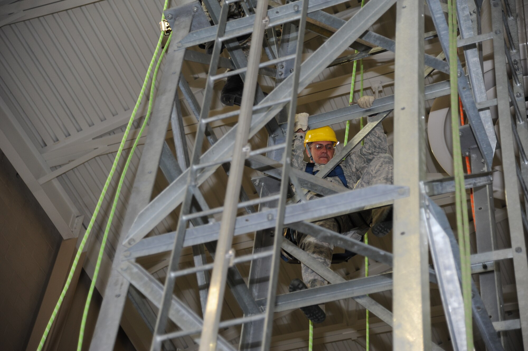 Col. Albert Elton, Installation Excellence Selection Board member, climbs up a training climbing tower used by the 338th Training Squadron at Matero Hall, Jan. 11, 2013, Keesler Air Force Base, Miss. Keesler is one of the top two bases competing for the Commander-in-Chief's Annual Award for Installation Excellence, with a $1 million top prize for quality of life initiatives.  Keesler showed the board members various examples of team problem solving, unit cohesiveness and enhanced productivity throughout their two-day visit.  (U.S. Air Force photo by Kemberly Groue)