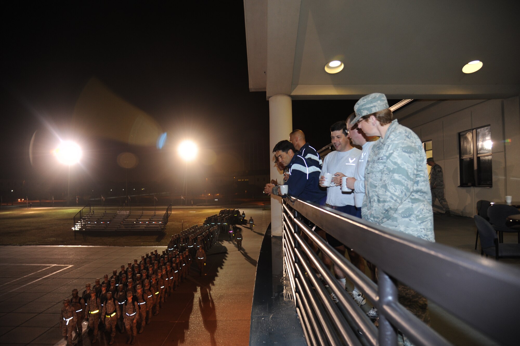 Installation Excellence Selection Board members and 81st Training Wing base leadership watch from the balcony of the Levitow Training Support Facility as training students march in formation to their classes Jan. 11, 2013, Keesler Air Force Base, Miss.  The IESB visited the two finalist bases to evaluate how well the base improved work environments, quality of life and increased customer satisfaction to determine the winner of the Commander-in-Chief's Annual Award for Installation Excellence.  The first-place base wins $1 million towards quality of life initiatives while the second-place base earns $500,000.  (U.S. Air Force photo by Kemberly Groue)