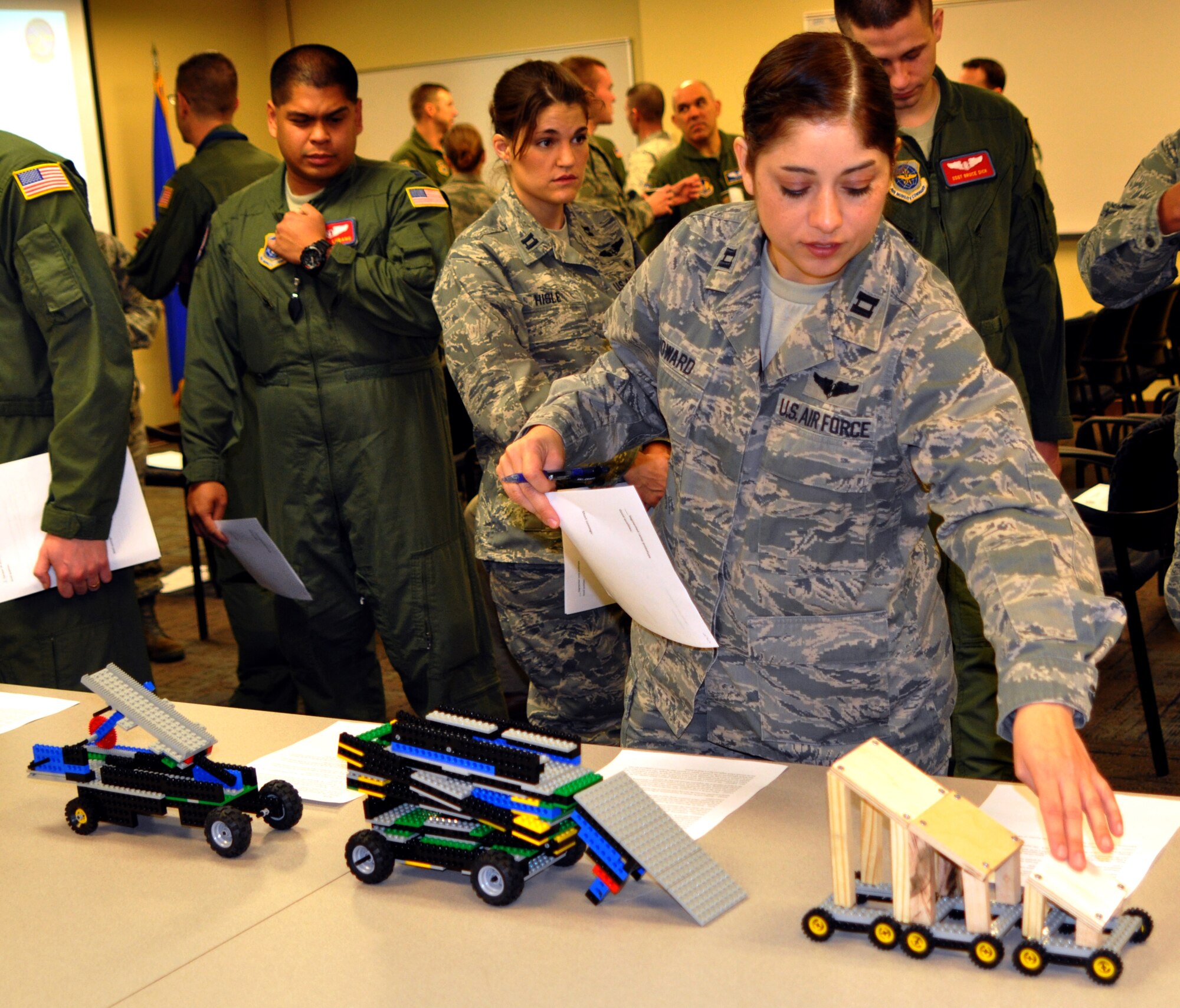 Capt. Blanca Howard, 375th Aeromedical Evacuation Squadron mission management element leader,  looks at different prototypes during a collaboration workshop Jan. 15, 2013 at Scott AFB, Ill.  A group of Air Force Academy seniors designed patient loading system prototypes so that medical personnel would be able to feel and see how they work, and provide feedback to the designers.  (U.S. Air Force photo/Staff Sgt. Maria Bowman)