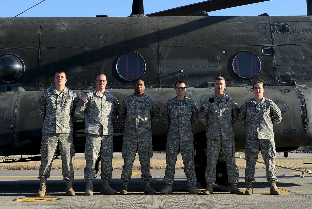 Soldiers from the Army Reserve's 5th Battalion, 159th Aviation Regiment, stand with a CH-47 Chinook at Fort Eustis, Va., Jan. 10, 2013. The battalion is currently serving in the Defense CBRN Response Force, a task force established to support relief efforts following catastrophic terrorist or natural disaster events. (U.S. Air Force photo by Staff Sgt. Ashley Hawkins/Released)