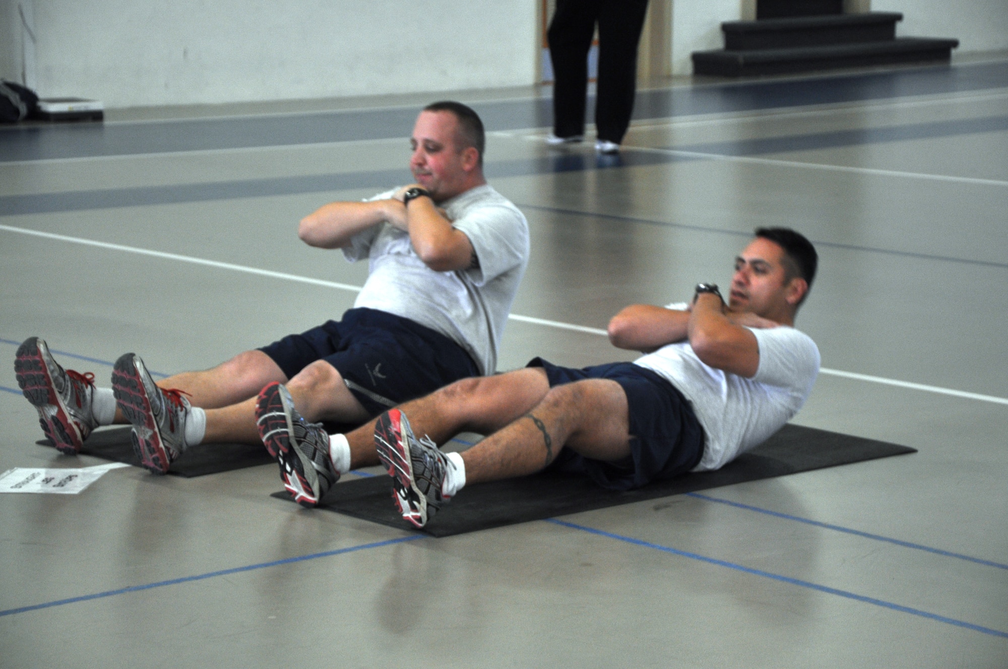 GOODFELLOW AIR FORCE BASE, Texas – Staff Sgt. Robert Prince, 17th Training Support Squadron unit training manager, and Master Sgt. Gregorio Escamilla, 17th Training Support Squadron flight chief, participate in one of the circuit training stations at the Carswell Field House here, Jan. 14. This station and others were incorporated into the circuit training to focus on the abdominal sections. (U.S Air Force photo/ Airman 1st Class Joshua Edwards)