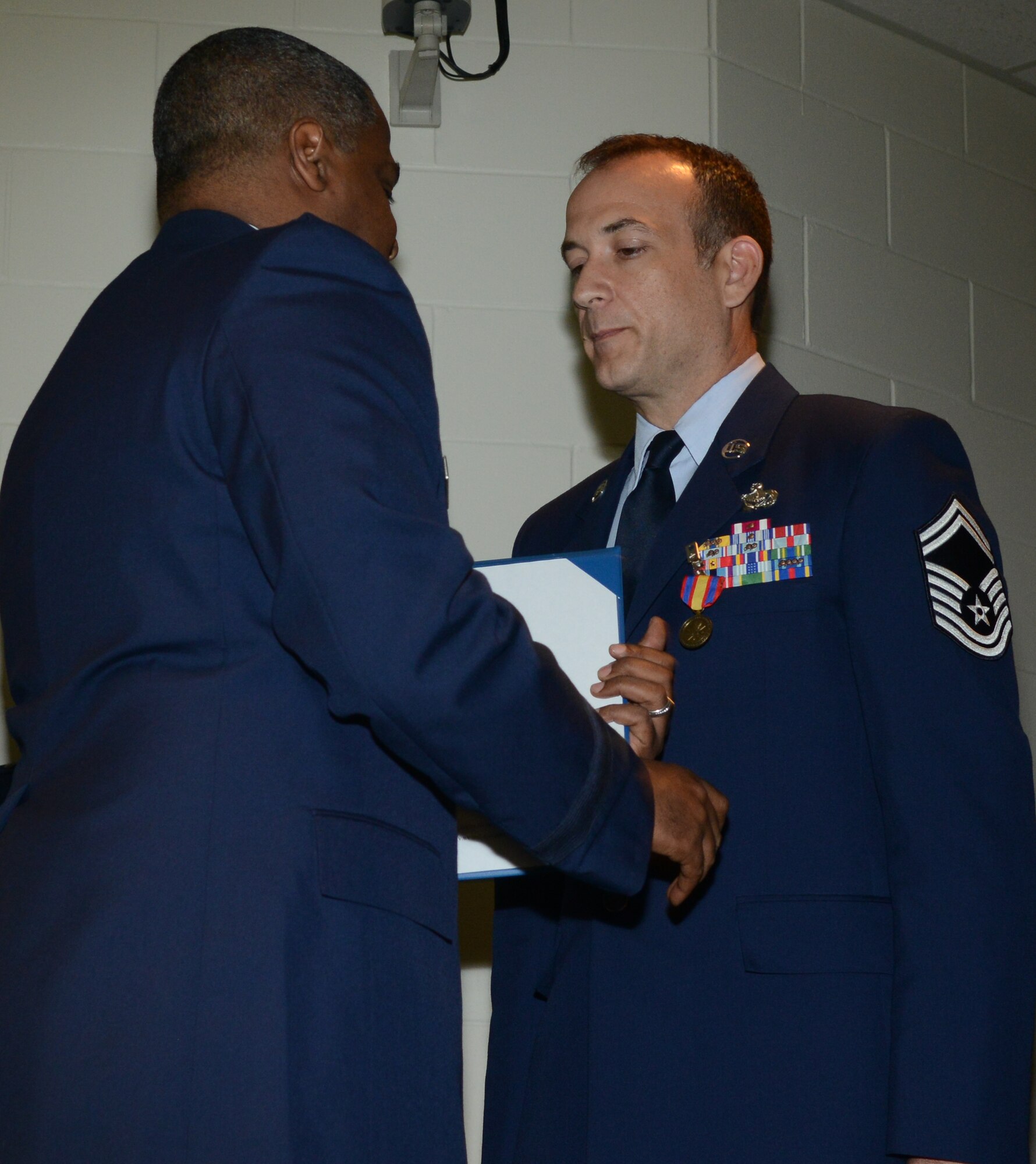 Brig. Gen. Brian Newby, chief of staff for the Texas Air National Guard pins the Texas Medal of Merit on Senior Mater Sgt. Edward Walden, 136th Airlift Wing Senior Non-Commissioned Officer of th Year for his outstanding performance in the Wing. Walden competed amongst fellow SNCOs thoughout the State. (National Guard photo by Senior Master Sgt. Elizabeth Gilbert)