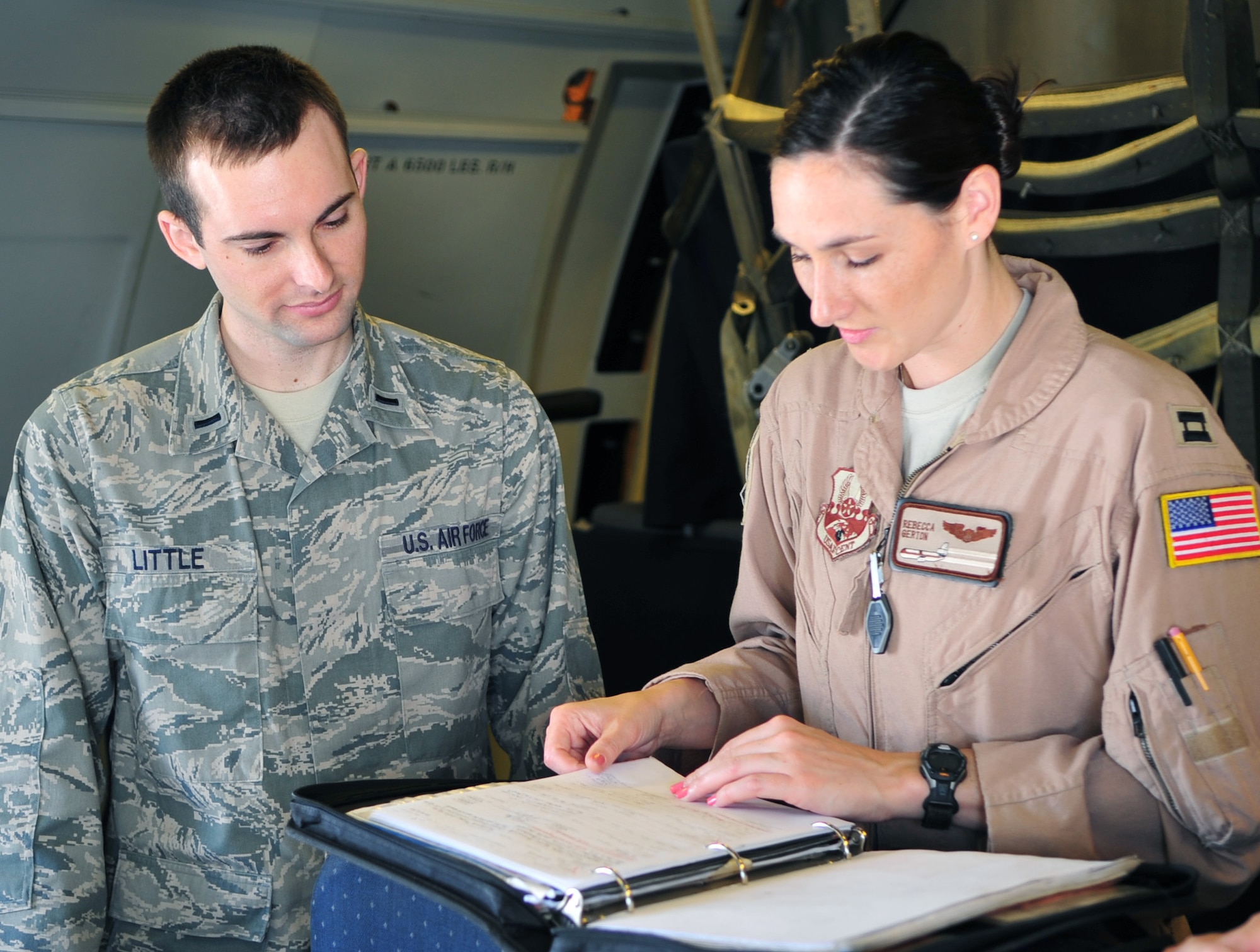 Air Force 1st Lt. Ryan Little, 908th Expeditionary Air Refueling Squadron intelligence operations officer in charge, briefs Air Force Capt. Rebecca Gerton, 908th EARS aircraft commander, on Jan. 7 inside a KC-10 Extender. If the intelligence picture changes after the crew's initial brief, intel ops will go to the air crew on the flightline to provide an update, ensuring the crew is prepared to safely accomplish their mission. (U.S. Air Force photo/Staff Sgt. Timothy Boyer)